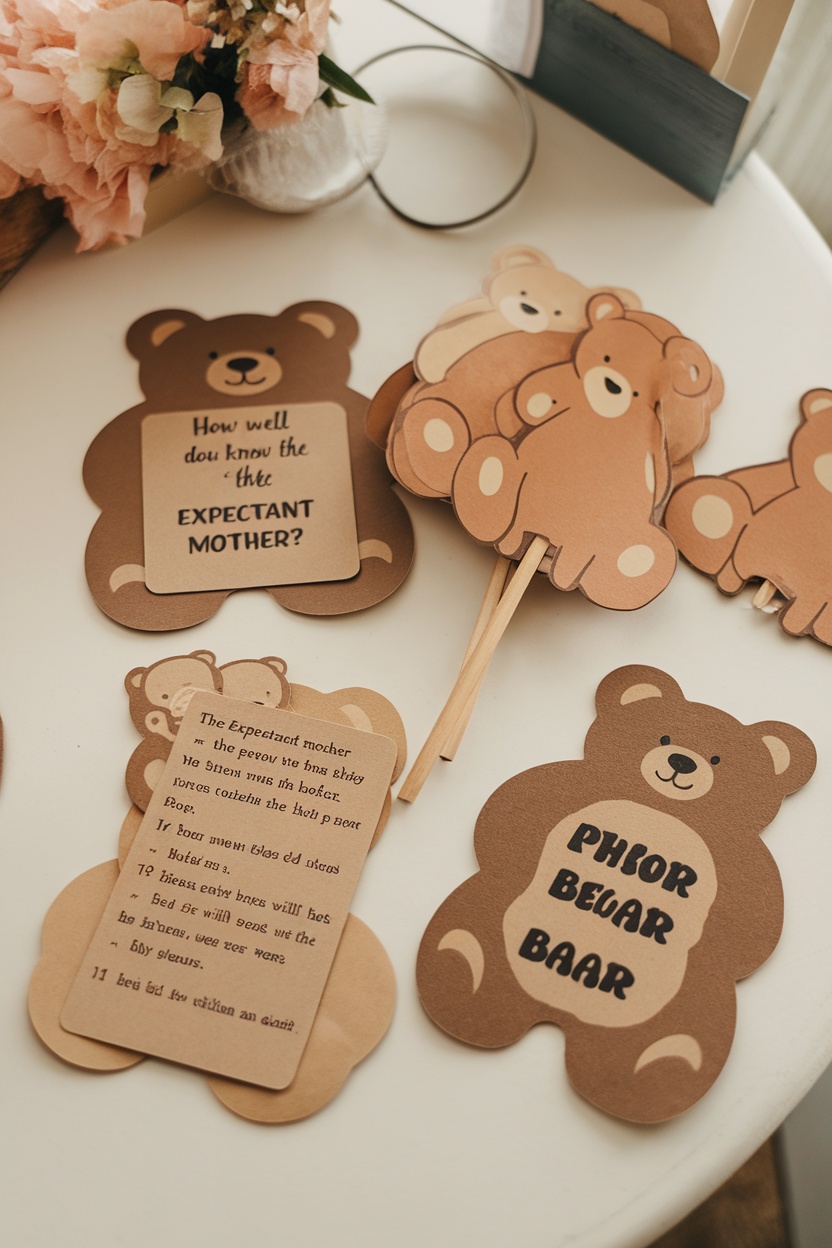 Teddy bear baby shower game cards on a table with a flower vase.